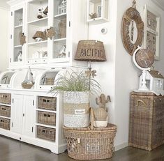 a white hutch with wicker baskets on the floor