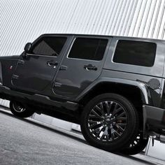 a black jeep parked in front of a building