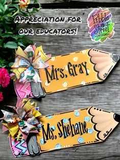 two wooden signs with the words mrs gray and mr sherman on them next to some flowers