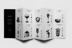 an open book with black and white illustrations on the front, side and back pages