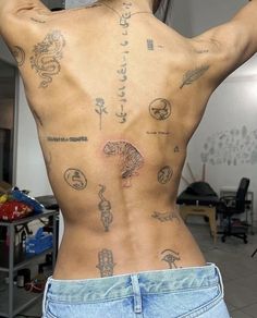 the back of a man with tattoos on his body