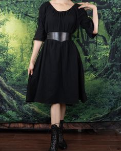 A timeless and ever-flattering classic, our Black Cotton Puff Sleeve Chemise makes the perfect dress to wear on it's own, under a corset, or accessorized with your favorite renaissance faire accessories. This dress is made from super soft 100% textured cotton fabric, featuring puff sleeves and an optional on or off the shoulder silhouette. Adjustable ties above the elbow create two voluminous puffs in the sleeves, and an elastic neckline keeps our chemise snug and fitted around your shoulders and arms. This listing is for the black dress only, other items in these photos can be purchased separately from our shop. Fitted Medieval Summer Dress, Fitted Medieval Style Summer Dress, Fitted Medieval Dress For Summer, Fall Cosplay Corset Dress, Medieval Corset Dress Costume, Gothic Corset Dress For Medieval Festivals, Elegant Underbust Corset Belt For Cosplay, Elegant Corset Dress For Larp, Medieval Style Corset Dress For Cosplay