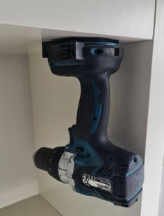 a cordless drill is attached to the wall