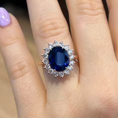 a woman's hand with a blue ring on it