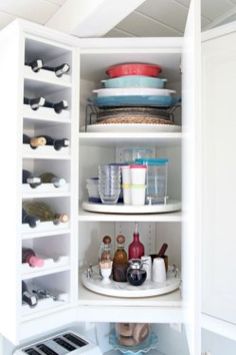 an open refrigerator with dishes and cups in it