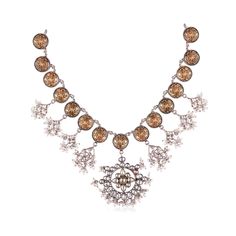 The Niovi Lotus Jadau Necklace features delicate lotus motifs linked together, adorned with beautiful fish charms encrusted with semi-precious polkis. The necklace also showcases a stunning main pendant made with polki and jadau setting. The two-tone antique finish with pearl hangings adds a touch of vintage charm, making it a perfect complement to any ethnic or fusion outfit. Ornate Silver Jeweled Necklaces, Ornate Silver Jeweled Necklace, Elegant Antique Gold Necklaces For Festivals, Elegant Antique Gold Necklace For Festivals, Silver Jeweled Kundan Temple Necklace, Elegant Kundan Temple Necklace In Antique Gold, Silver Jeweled Temple Necklace For Festivals, Elegant Antique Gold Kundan Necklace With Intricate Design, Elegant Antique Gold Necklaces For Festive Occasions