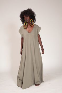 "This oversize almond green maxi dress is a great addition to your wardrobe. It has a very loose fit, short sleeves, a deep v-neck and best of all - pockets! The dress is made out of top quality modal lycra and can be suitable for both the day or a night out on the town. Suitable for summer and winter. Fits many body figures. OBI BELT CAN BE PURCHASED SEPARATELY Fabric: Modal Lycra ONE SIZE: Bust- 96cm / 37.7 \" Hips - 134cm / 52.7\" Sleeve - 24cm/ 9.4\" This dress is available in two different Relaxed Fit Maxi Dress In Lagenlook Style, Lagenlook Maxi Dress With Relaxed Fit, Relaxed Fit Lagenlook Maxi Dress, Green Bohemian Maxi Dress For Daywear, Oversized Green Maxi Dress For Spring, Oversized Lagenlook Maxi Dress, Flowy Lagenlook Maxi Dress, Oversized Maxi Dress For Daywear, Green Long Maxi Dress For Daywear