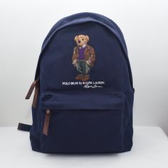 Polo Ralph Lauren Men's Polo Bear Canvas Backpack. Color:Newport Navy. Size:16.5" H X 12.75" L X 5.75" D. From Polo Ralph Lauren, This Backpack Features: Polo Bear, “Polo Bear By Ralph Lauren,” And “Ralph Lauren” Script Embroidered At The Front Leather Top Handle Two Adjustable Buckled Shoulder Straps Two-Way Top Zip Closure Leather Zipper Pulls Front Zip Pocket Interior Laptop Sleeve 16.5" H X 12.75" L X 5.75" D Shell And Lining: Cotton Trim: Leather Bear Canvas, Ralph Lauren Polo Bear, Ralph Lauren Bags, Polo Bear, Canvas Backpack, Zipper Pulls, Leather Zipper, Ralph Lauren Polo, Polo Ralph Lauren Mens