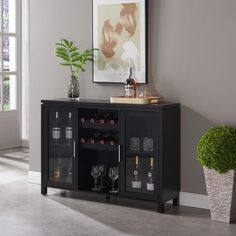 The Neiman Buffet / Wine Rack (Black) is a stunning addition to any dining area or kitchen. Made from sturdy wood and finished in a smooth black, this buffet has a contemporary clean look that blends seamlessly with any decor. The buffet boasts two cabinets on either side, each with two glass doors that allow for a clear view of the contents. The centerpiece of the buffet is the two open wine shelves, which provide a convenient and accessible storage space for your favorite bottles. Specifications - Finish: Black - Knobs: Silver Finish - Material: Wood - Doors: Glass Filled - Number of Cabinets: 2 - Number of Doors: 2 - Number of Shelves: 2 Interior; 1 Exterior - Number of Wine Rack Shelves: 2 - Assembly Required: Yes Dimensions - Overall Dimensions: 42"L x 12"W 30"H - Overall Inner Side C Bar Storage Cabinet, Open Wine, Wine Shelf, Wood Wine Rack, Table Top Wine Rack, Cabinet Table, Modern Storage Cabinet, Wine Bar Cabinet, Cabinet Sideboard