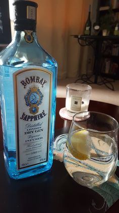 a bottle of alcohol sitting next to a glass on a table