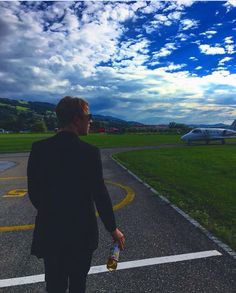 a man in a suit walking towards an airplane