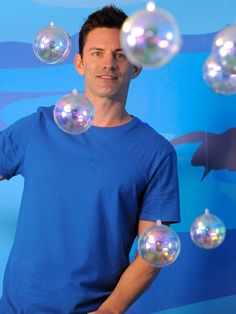 a man is standing in front of bubbles that look like he's blowing them