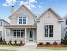 a white house with two story windows on the front