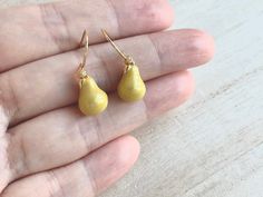 These are dainty pear earrings. They are made of the followings: (1) gold plated green epoxy pear charm (size: 14 x 8.5 mm) (2) gold plated or 14KGF earring hooks ✏️ Please choose your desired earring hooks 【ADDITIONAL QUANTITY】 Kindly convo us if you require additional quantity and we will be happy to customize the order to meet your needs. 【BEFORE PURCHASE, PLEASE NOTE THE FOLLOWINGS】 ☆ VAT, GST and any other taxes from your country are NOT included in the listing price. Buyers are responsible Everyday Pear-shaped Gold Earrings, Handmade Gold Briolette Teardrop Earrings, Gold Briolette Teardrop Handmade Earrings, Delicate Pear-shaped Teardrop Earrings As Gift, Dainty Yellow Gold Teardrop Earrings Gift, Handmade Pear-shaped Teardrop Earrings Gift, Gold Hypoallergenic Pear-shaped Teardrop Earrings, Gold Pear-shaped Hypoallergenic Teardrop Earrings, Handmade Yellow Gold Teardrop Earrings