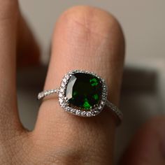 This halo ring features a 8*8mm cushion cut natural diopside and sterling silver finished with rhodium. Customization is available. It is made by hand, and it will take about 7 days to finish the ring after your payment is completed. Main stone: chrome diopside Diopside weight: Approx 2.40 ct Metal type: sterling silver finished with rhodium Accent stone: cz Customization is available, I also can make it with 14k solid gold (white or yellow or rose) and diamond accent stone, just feel free to co Chrome Diopside Ring, Gemstone Engagement Ring, Green Gemstone Ring, Ring Cushion, Cushion Cut Ring, Cushion Ring, Top Rings, Cushion Diamond, Gemstone Engagement