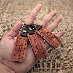 four leather luggage tags in the palm of someone's hand