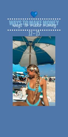 a beautiful woman sitting on top of a blue towel next to an umbrella and holding a drink