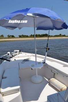 the inside of a boat with an umbrella and lounge chairs on the front deck area