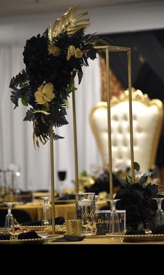 the table is set with black and gold decorations