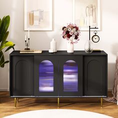 a black cabinet with purple lights on it in a living room next to a white rug