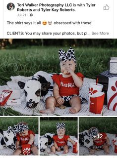 a baby sitting on top of a blanket next to a cow wearing a bandana