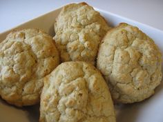 four cookies are sitting on a white plate