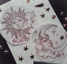 two stickers with the sun and moon drawn on them next to a marker pen