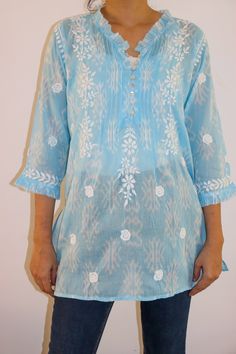 Introducing our Aztec Print Short Chikankari Kurta - a perfect blend of contemporary style and traditional craftsmanship. Made on super soft Cotton Mulmul Fabric with a Ruffle neckline, adorned with pleats and delicately crafted shell button loops, adds a touch of elegance to this chic piece.  Designed for both comfort and style, the kurta features side slits for ease of movement. Immerse yourself in the artistry of Chikan embroidery that graces every inch of this kurta, creating a captivating and timeless appeal.  Elevate your wardrobe with this unique fusion of Aztec prints and intricate Chikankari detailing - a statement of refined fashion for any occasion. Length - 28-30 inches Size -  S - fits bust 34 M - fits bust 36 L - fits bust 38 XL - fits bust 40 0X - fits bust 42 1X - fits bust Summer Blue Kurta With Embroidered Neckline, Blue Summer Kurta With Embroidered Neckline, Elegant Straight Kurta Tunic For Summer, Elegant Summer Straight Kurta Tunic, Elegant Spring Straight Kurta Tops, Spring Straight Kurta Blouse With Embroidered Neckline, Spring Embroidered Straight Kurta Blouse, Spring Embroidered Neckline Straight Kurta Blouse, Elegant Straight Kurta Tops For Summer