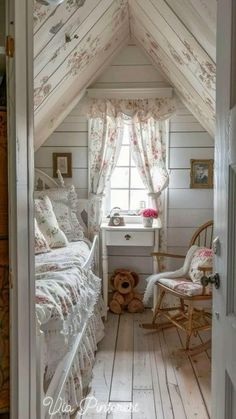 an attic bedroom with white walls and wooden floors, decorated in shabby style decor