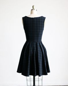 "PRE-ORDER - SHIPS IN 4 WEEKS -- The perfect little black dress that's just the right dash of prim mixed in with a little bit of proper. + D E T A I L S - an adorable vintage inspired mod retro day dress in simple black windowpane grid print - full pleated knee length skirt with hidden side pockets - deep v neckline with pointed self collar and fit and flare silhouette - a dress for all occasions : bridesmaids, weddings, events and parties Shopping for another color? SUNDAY is available in 5 col 1950s Style A-line Pleated Dress, Black Fitted A-line Plaid Dress, 1950s Style A-line Dress With Box Pleat, 1950s-inspired A-line Pleated Dress, Classic Fitted Dress With Accordion Pleats, Fitted Black Dresses With Accordion Pleats, Fitted Retro Knee-length Plaid Dress, Fitted Knee-length Retro Plaid Dress, Retro Fitted Knee-length Plaid Dress