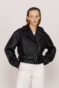 "KULAKOVSKY's black fitted biker jacket features a dropped shoulder line and is meticulously crafted from thick leather. The inclusion of an additional belt at the waist provides the flexibility to alter the silhouette, allowing you to achieve either a feminine cut or a more relaxed fit. Shop now at doors.nyc and #supportUKRAINE Belted Biker Jacket For Workwear, Black Belted Biker Outerwear, Black Biker Outerwear With Belt, Edgy Belted Biker Jacket For Work, Chic Black Biker Jacket With Belt Loops, Black Leather Jacket With Belt Loops For Fall, Edgy Black Belted Outerwear, Leather Jacket With Belt And Long Sleeves, Black Leather Outerwear With Belted Cuffs