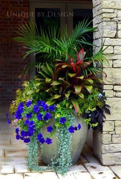 a planter filled with purple and blue flowers