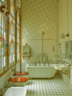 an old fashioned bathroom with stained glass windows