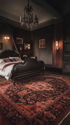 a large bed sitting on top of a wooden floor next to a chandelier