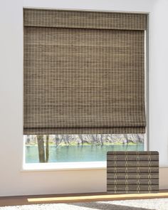 a room with a window covered in brown blinds