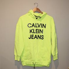 Neon Yellow/Green Calvin Klein Jeans Sweatshirt/Hoodie With Adjustable Waist And Hood, And "Calvin Klein Jeans" On The Front In Black, Fleece Lined Inside, Size Small. Yellow Letter Print Sweatshirt For Fall, Trendy Yellow Crew Neck Sweatshirt, Green Logo Print Sweatshirt For Spring, Trendy Yellow Hoodie With Letter Print, Trendy Yellow Sweatshirt With Letter Print, Yellow Long Sleeve Sweatshirt Athleisure, Yellow Long Sleeve Sweatshirt In Athleisure Style, Yellow Long Sleeve Sweatshirt For Athleisure, Oversized Yellow Sweatshirt With Letter Print