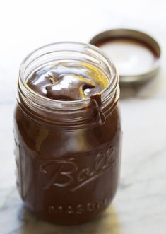 a jar filled with liquid sitting on top of a table