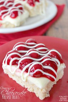 a piece of cherry cheesecake with white icing on a red plate