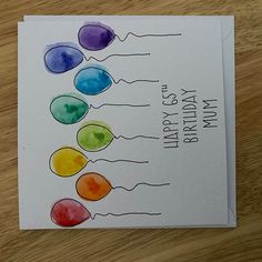 a birthday card with the words happy birthday on it and watercolor balloons in different colors