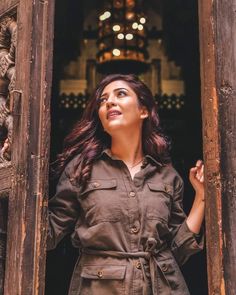 a woman standing in an open doorway looking up