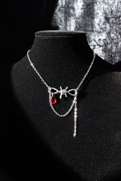 "This barbed wire necklace with a red glass drop bead looks a little vicious but delicate and pretty. The Goth vibe is there but it's not overpowering. The barbed wire charm looks a little like a bow or an infinity sign - up to you to interpret. Either way it's not scary, it's sparkly and elegant. You'll have to select the necklace length before checkout. I think the necklace looks best when the barbed wire charm sits right at your collar bone. But you'll have room to play with the length becaus Blood Necklaces, Blood Drop Necklace, Barb Wire Necklace, Red Edgy Metal Necklace, Edgy Red Metal Necklace, Red Wire Wrapped Metal Necklace, Adjustable Black Vampire Necklace, Barbed Wire Necklace, Wire Charm