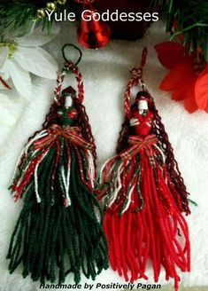 two red and green tassels hanging from a christmas tree