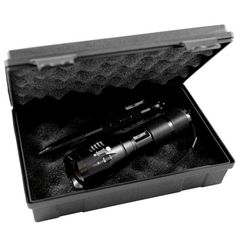 a black and white photo of a flashlight in a case