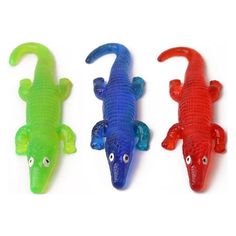 three plastic alligators with different colors and sizes