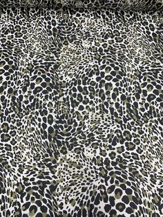 an animal print bed spread with black and white spots