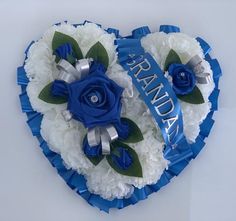 two blue and white flowers in the shape of a heart with congratulations written on it