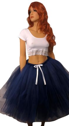 Step into elegance and grace with our Beautiful Navy Blue Tutu Skirt. This stunning skirt is perfect for any occasion, whether it's a special event, a party, or simply a day when you want to feel extra special. The skirt is meticulously crafted by tying hundreds of pieces of tulle to a comfortable elastic band. This technique creates a full and voluminous look, giving the skirt a mesmerizing and fluffy appearance. The deep navy blue color adds an element of sophistication, making you stand out with style and confidence. To add a touch of elegance, the skirt is adorned with a delicate white satin bow, creating a beautiful contrast against the navy blue tulle. This subtle detail adds an extra layer of charm and completes the overall look. Measuring at a length of 25 inches, this tutu skirt f Blue Tutu Skirt, Adult Tutu Skirt, Blue Tutu, Deep Navy Blue, Blue Tulle, Fall Skirts, White Bow, Satin Bow, Navy Blue Color