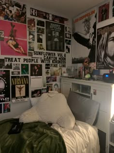 a bedroom with posters on the wall and a bed