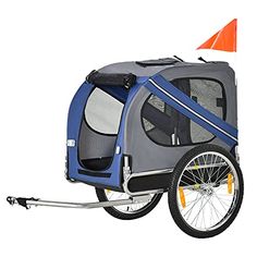 a bike trailer with a dog in it and an orange cone on the back wheel