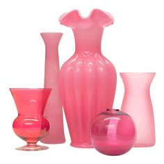 pink vases and other glass items on a white background